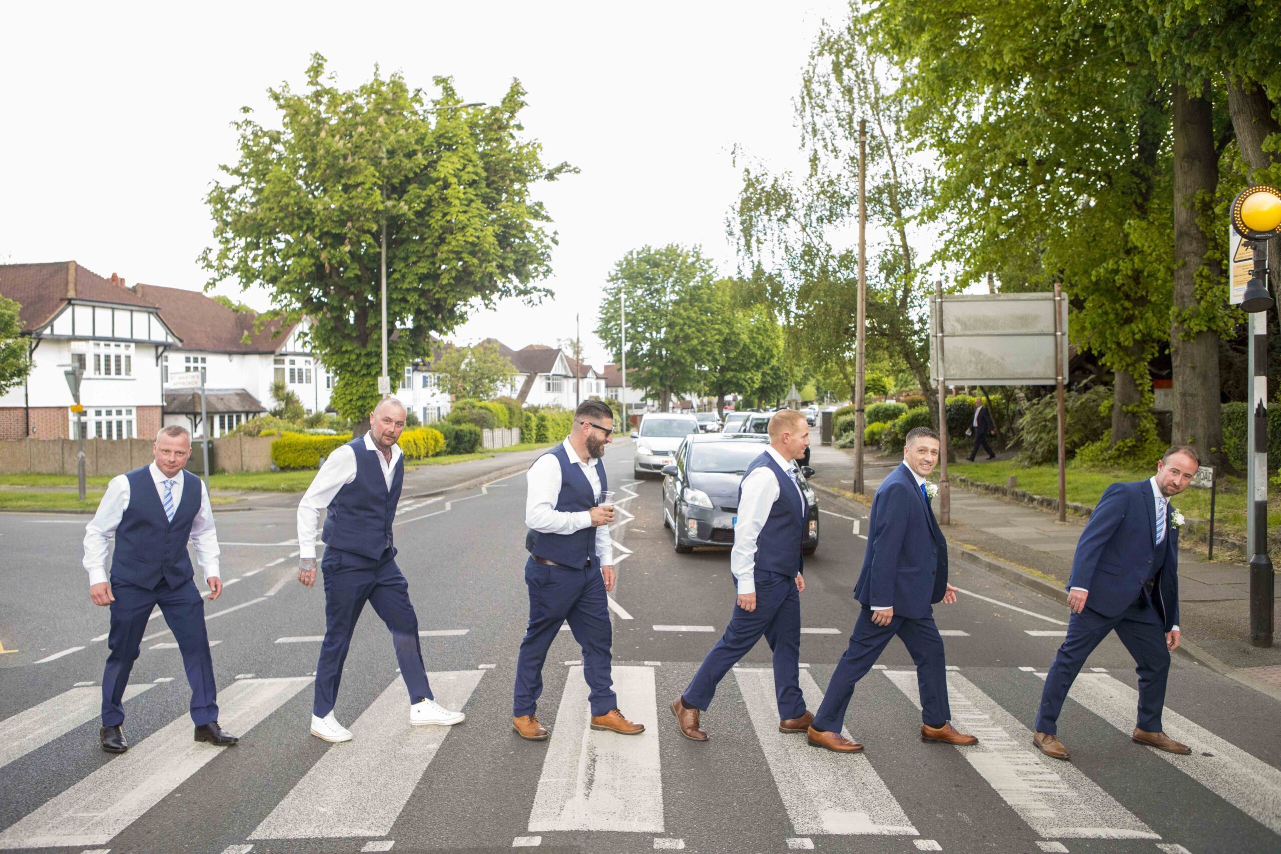 Groomsmen recreating the famous Beatles Abbey Road crossing photo