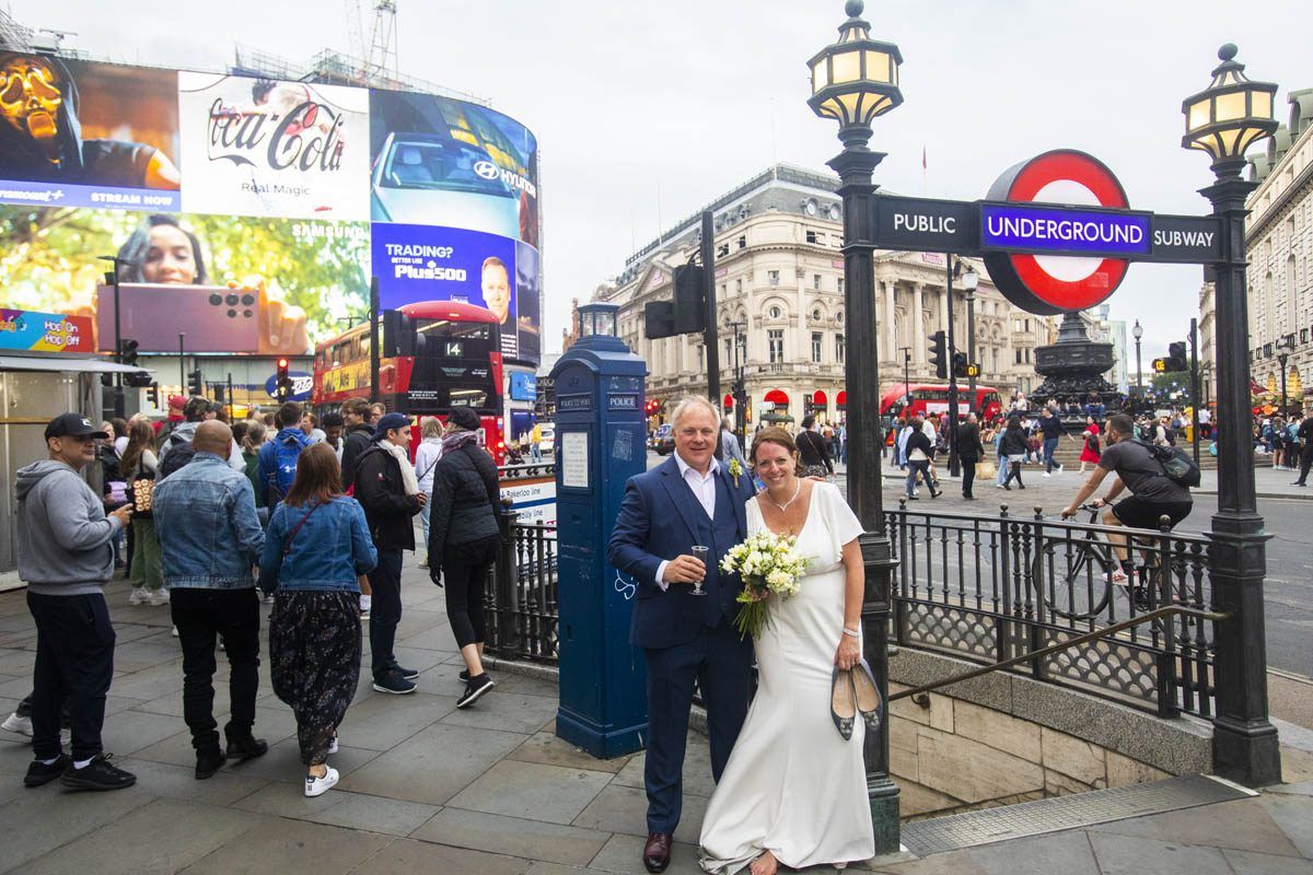 Wedding couple in front of St James Street London Underground sign